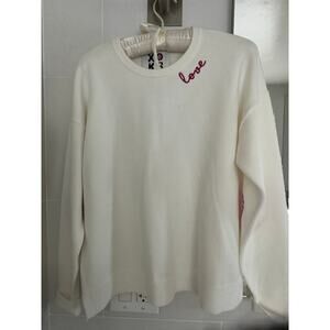 Kerri Rosenthal white sweater with love heart embroidery